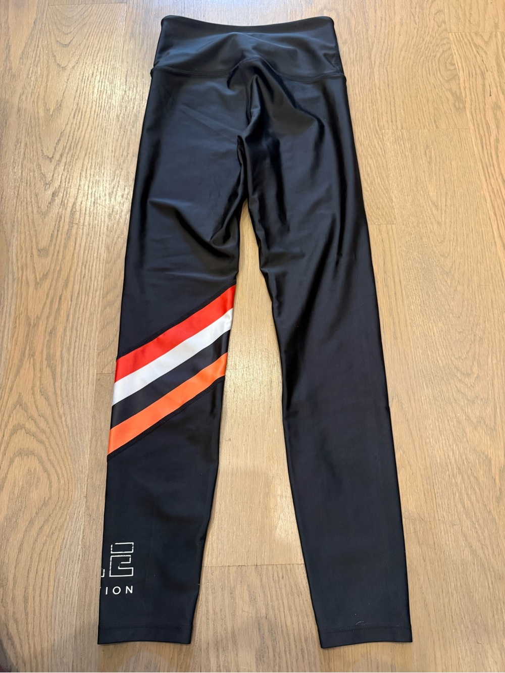 P.E Nation Black womens leggings with Orange, Red and White Stripes